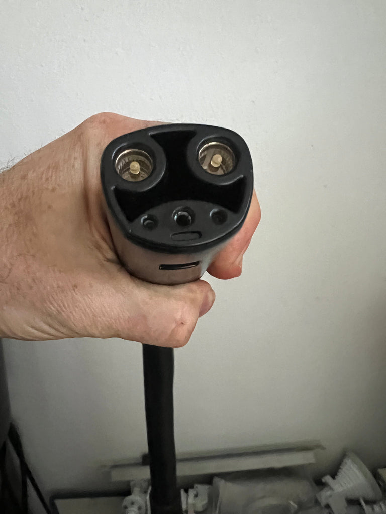 Tesla Gen 2 charger Universal Mobile Connector UMC charging with 220-Volt and 110-Volt adapters.